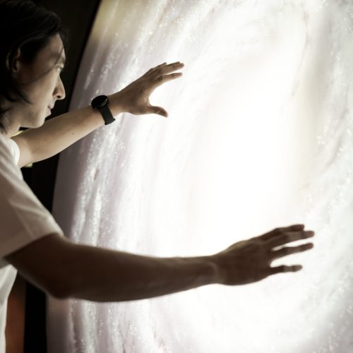 Man experiencing the universe at a planetarium